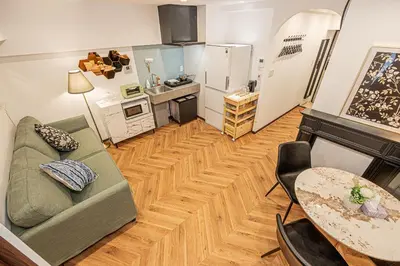 a living room with a couch and a table at Within easy reach of Shinjuku bustling district 4 minutes walk from nearest station 2 room apartment with lift Suitable for families and groups in Tokyo