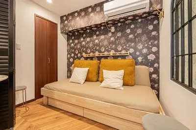 a bedroom with a bed with yellow pillows at Within easy reach of Shinjuku bustling district 4 minutes walk from nearest station 2 room apartment with lift Suitable for families and groups in Tokyo