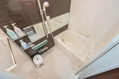 a small bathroom with a shower and a sink at Within easy reach of Shinjuku bustling district 4 minutes walk from nearest station 2 room apartment with lift Suitable for families and groups in Tokyo