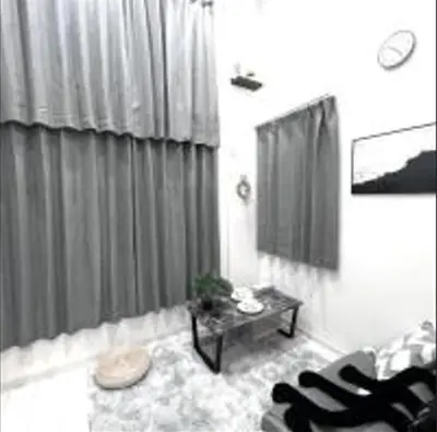 a living room with a couch and a table at Shinjuku sumika5 in Tokyo