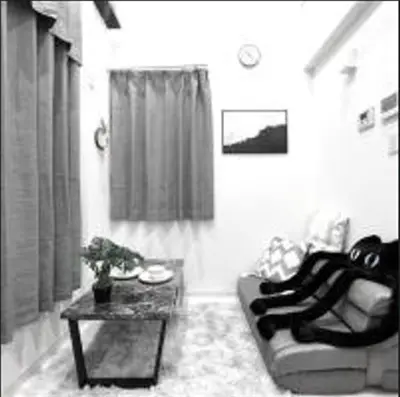 a living room with a couch and a table at Shinjuku sumika5 in Tokyo