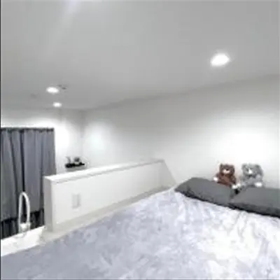 a bedroom with a bed with two teddy bears on it at Shinjuku sumika5 in Tokyo