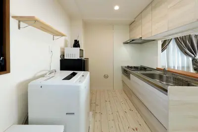 a small kitchen with a sink and a dishwasher at Shimoshinmei Apartment 301 by Tranova in Tokyo