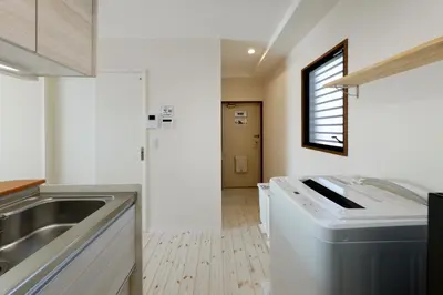 a kitchen with a sink and a washing machine at Shimoshinmei Apartment 301 by Tranova in Tokyo