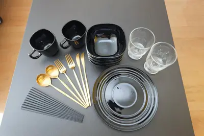 a table with plates and forks and wine glasses at Shimoshinmei Apartment 301 by Tranova in Tokyo