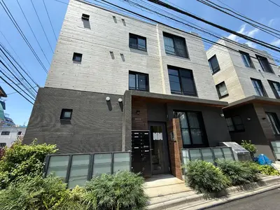 a large brick building with glass windows at Proto Shibuya Shinsen Style in Tokyo