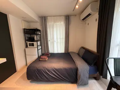 a small bedroom with a bed and a window at Proto Shibuya Shinsen Style in Tokyo