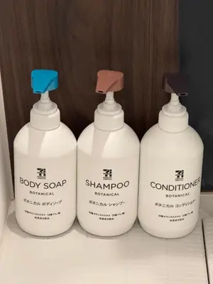 a group of four bottles of soap on a shelf at Proto Shibuya Shinsen Style in Tokyo