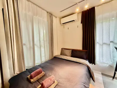 a bedroom with a bed with two pillows on it at Proto Shibuya Shinsen Style in Tokyo