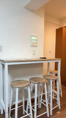 a kitchen with a counter and two stools at \u30b9\u30ab\u30a4\u30c4\u30ea\u30fc\u306e\u5bbf 502 in Tokyo