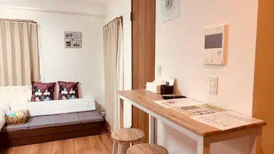 a small room with a bed and a desk with stools at \u30b9\u30ab\u30a4\u30c4\u30ea\u30fc\u306e\u5bbf 502 in Tokyo