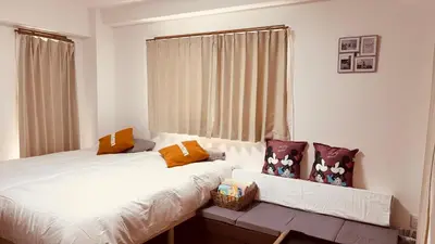 a bedroom with two beds and a window at \u30b9\u30ab\u30a4\u30c4\u30ea\u30fc\u306e\u5bbf 502 in Tokyo