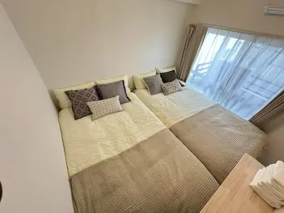 a large bed with pillows on it in a bedroom at \u611b\u306e\u5c4b\u30db\u30c6\u30eb\u767e\u4eba\u753a in Tokyo