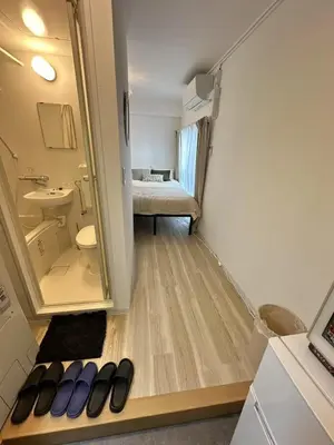 a room with a bathroom with a sink and a mirror at \u611b\u306e\u5c4b\u30db\u30c6\u30eb\u767e\u4eba\u753a in Tokyo