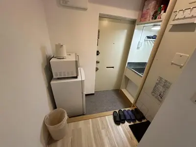 a small kitchen with a refrigerator and a microwave at \u611b\u306e\u5c4b\u30db\u30c6\u30eb\u767e\u4eba\u753a in Tokyo
