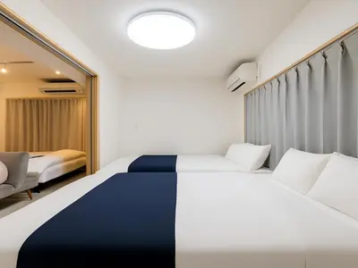 a hotel room with a bed and a chair at Asakusa-Akihabara-Family-Friendly Stay- 4min Walk to Oshiage Sta- Switch & Mobile Wi-Fi in Tokyo