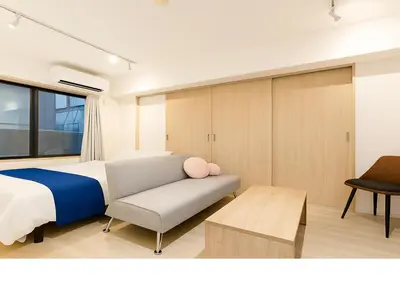 a bedroom with a bed and a couch at Asakusa-Akihabara-Family-Friendly Stay- 4min Walk to Oshiage Sta- Switch & Mobile Wi-Fi in Tokyo