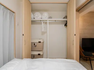 a bedroom with a white bed and a window and a chair at Asakusa-Akihabara-Family-Friendly Stay- 4min Walk to Oshiage Sta- Switch & Mobile Wi-Fi in Tokyo