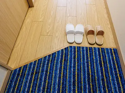 a pair of shoes on the floor next to a blue rug at HOTEL DREAM GATE maihama - Main & Annex in Urayasu