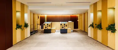 a hallway of a hotel with yellow walls at HOTEL DREAM GATE maihama - Main & Annex in Urayasu