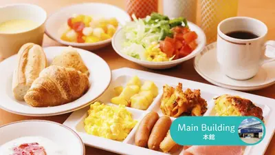 a table with plates of breakfast foods and a cup of coffee at HOTEL DREAM GATE maihama - Main & Annex in Urayasu