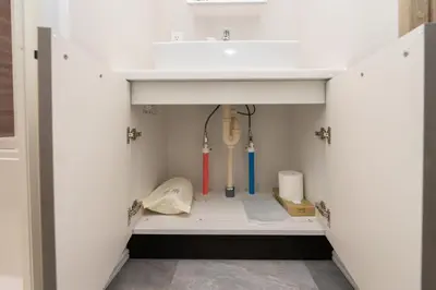 a bathroom with a sink under a counter with a sink at ZAITO Waseda Terra Hotel in Tokyo