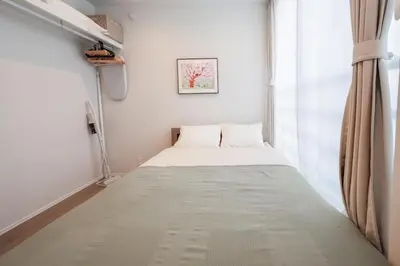 a small bed in a room with a window at ZAITO Waseda Terra Hotel in Tokyo