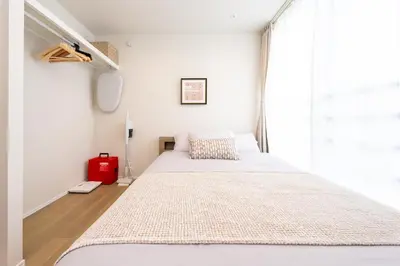 a bedroom with two beds and a window at ZAITO Waseda Terra Hotel in Tokyo