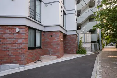 a brick building with a sink on the side of it at ZAITO Waseda Terra Hotel in Tokyo