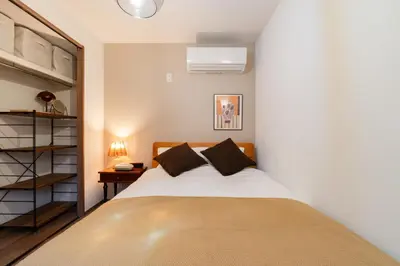 a bedroom with a bed and a book shelf at THE CAMINO Nakano 202 in Tokyo