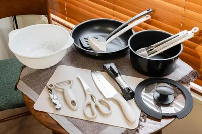 a table with utensils on a table with pots and pans at THE CAMINO Nakano 202 in Tokyo