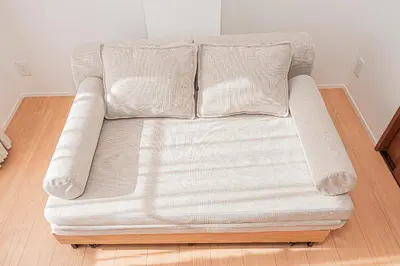 a couch sitting on top of a wooden floor at Sheath Okachimachi Apartment Hotel in Tokyo