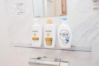three bottles of cleaning products on a shelf in a bathroom at Sheath Okachimachi Apartment Hotel in Tokyo