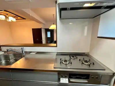 a kitchen with a stove and a sink at North Tokyo Grand Inn in Tokyo