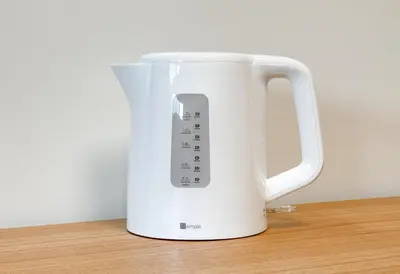 a white appliance with a remote control on a table at \u304b\u3064\u3089301 in Tokyo