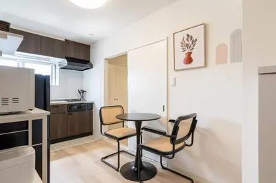a kitchen with a table and chairs in a room at \u304b\u3064\u3089301 in Tokyo