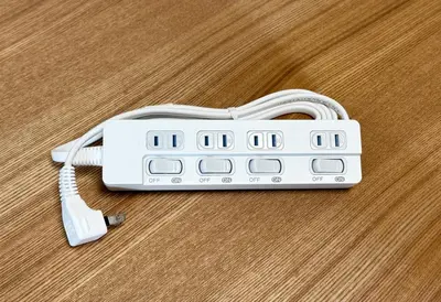 a white remote control sitting on a wooden floor at \u304b\u3064\u3089301 in Tokyo