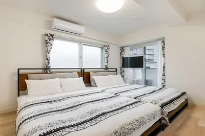 a bedroom with a large bed and a window at \u304b\u3064\u3089301 in Tokyo