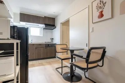 a kitchen with a table and chairs in a room at \u304b\u3064\u3089301 in Tokyo