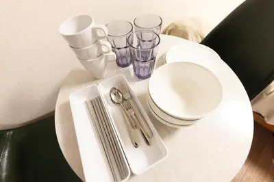 a small white table with glasses and scissors on it at \u30d9\u30eb\u30a8\u30a2\u5927\u4e45\u4fdd205 in Tokyo