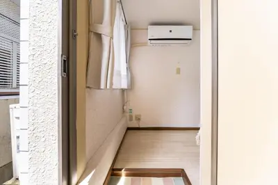 a hallway with a door leading into a room at shinjuku-ookubo Apartment room101 in Tokyo