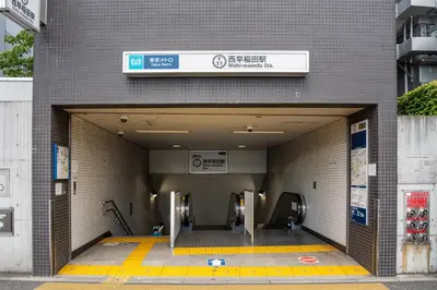 a building with a subway entrance with escalators at shinjuku-ookubo Apartment room101 in Tokyo