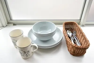 three cups and a basket on a window sill at shinjuku-ookubo Apartment room201 in Tokyo