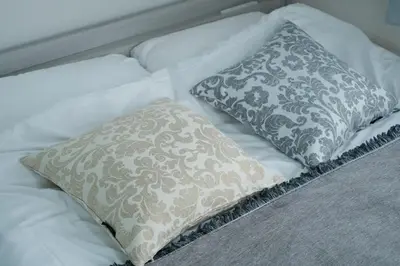 a white bed with two pillows on it at shinjuku-ookubo Apartment room201 in Tokyo