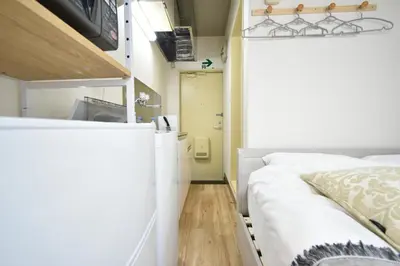 a small room with a bed and a kitchen at shinjuku-ookubo Apartment room201 in Tokyo