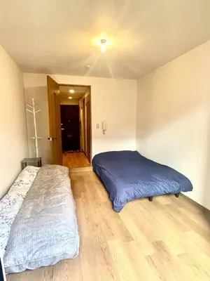 a bedroom with a bed and a cross on the ceiling at Tokyo West Shinjuku close to Shinjuku Chuo Park in Tokyo