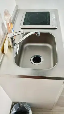 a sink with a cell phone on top of it at Tokyo West Shinjuku close to Shinjuku Chuo Park in Tokyo