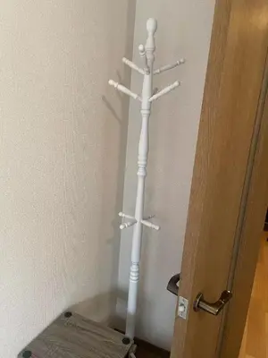 a white towel rack in a corner next to a door at Tokyo West Shinjuku close to Shinjuku Chuo Park in Tokyo