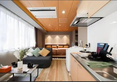 a living room with a couch and a bed at Oshiage SAIEI Hotel 401 in Tokyo