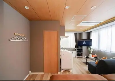 a living room with a couch and a tv at Oshiage SAIEI Hotel 401 in Tokyo